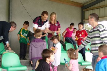 County Hurling/Camogie players Cyril Donnellan and Niamh Kilkenny present the medals.