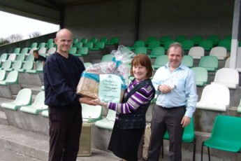 Brian Kenny, Oranbay 90 presents Delia Mentane with her raffle prize kindly sponsored by Brierfield Bouncy Castles