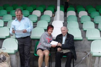 Bernie Mulryan, Athenry AC presented with her prize by the great Willie Morris
